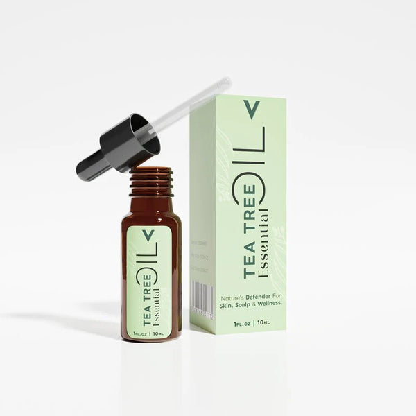 Tea tree essential oil bottle with dropper and product box for skin and scalp wellness